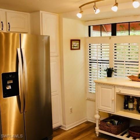 kitchen with dark hardwood / wood-style floors, track lighting, white cabinets, and stainless steel fridge with ice dispenser