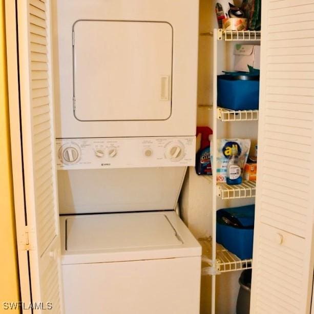 clothes washing area with stacked washer and dryer