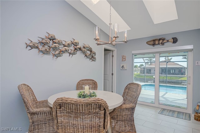 tiled dining area featuring lofted ceiling and an inviting chandelier