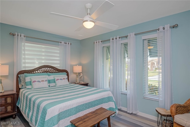 bedroom with hardwood / wood-style floors and ceiling fan