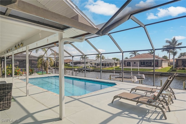 view of swimming pool featuring a water view, glass enclosure, and a patio area