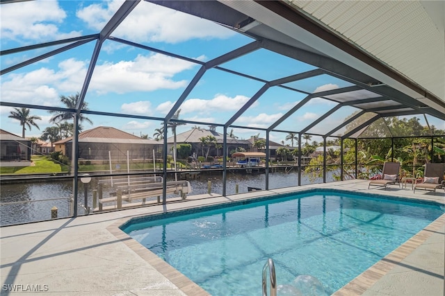 view of swimming pool featuring a water view, a lanai, and a patio area