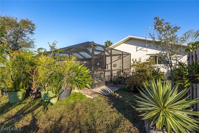 view of yard featuring glass enclosure