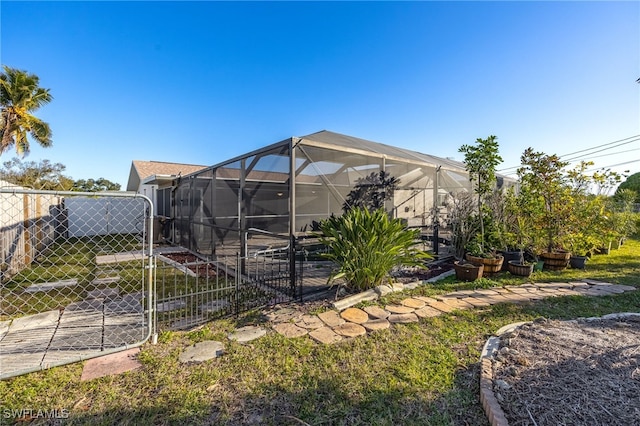 rear view of property featuring a lanai