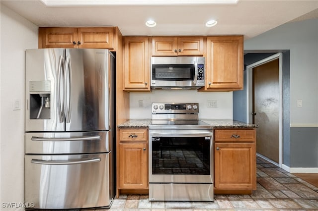 kitchen with stainless steel appliances and stone countertops