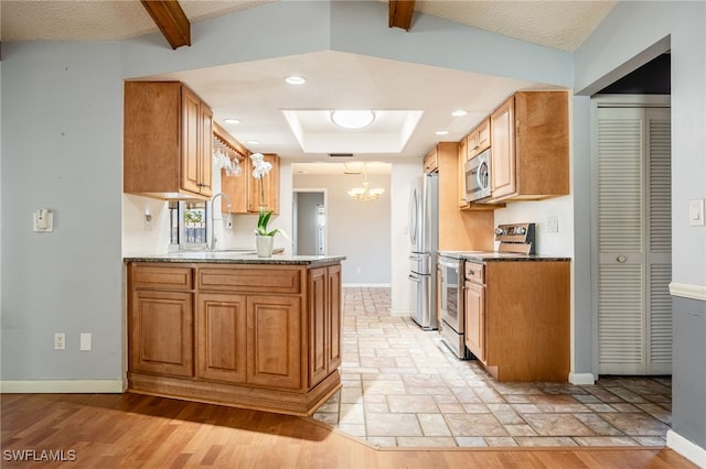 kitchen with beam ceiling, stainless steel appliances, light stone countertops, kitchen peninsula, and a chandelier