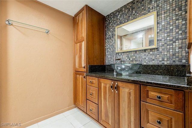 bathroom featuring vanity, tile patterned floors, and decorative backsplash