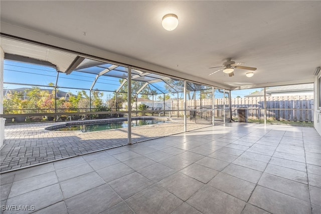 unfurnished sunroom with ceiling fan