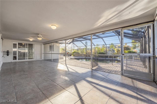 unfurnished sunroom with a healthy amount of sunlight and ceiling fan