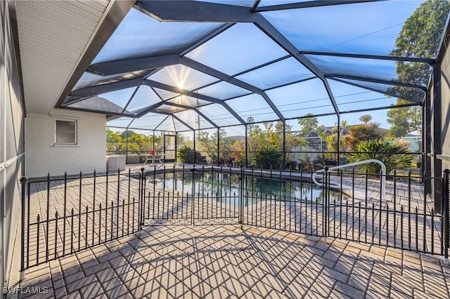 view of pool featuring a lanai, a patio area, and a water view