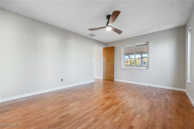 unfurnished room featuring ceiling fan, light hardwood / wood-style flooring, and a textured ceiling