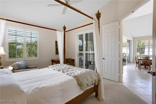 bedroom with lofted ceiling, light colored carpet, ceiling fan, and light tile patterned floors