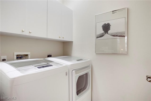 laundry room with washer and clothes dryer and cabinet space