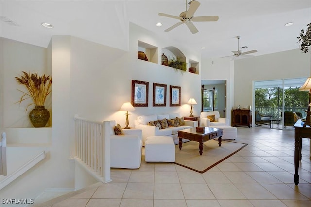 living area with light tile patterned floors, recessed lighting, a high ceiling, a ceiling fan, and visible vents