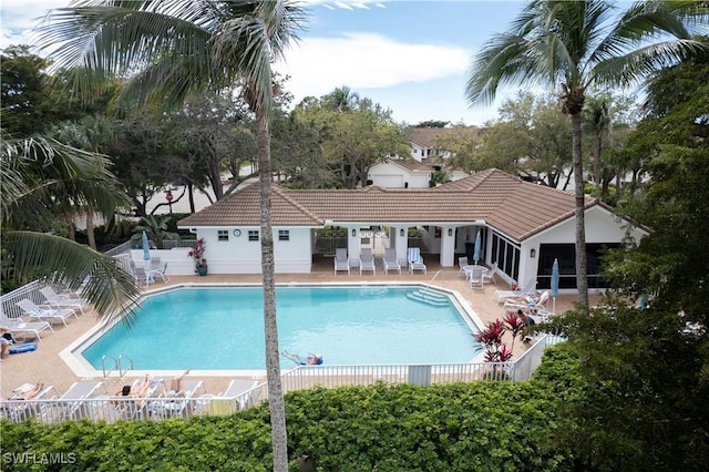 pool featuring fence and a patio