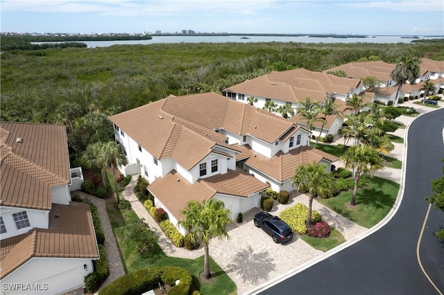 drone / aerial view featuring a residential view and a water view