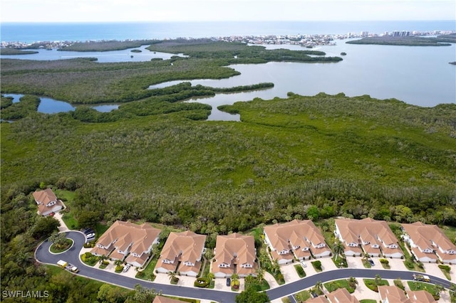 drone / aerial view featuring a water view and a residential view