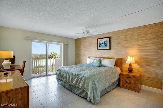 bedroom featuring access to exterior, light tile patterned floors, a textured ceiling, and ceiling fan