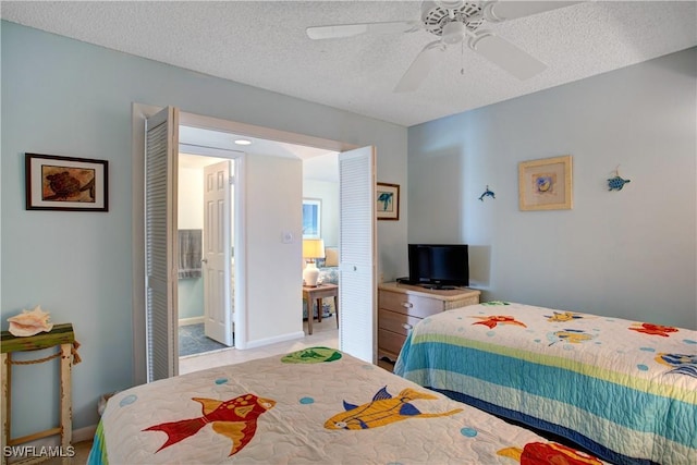 bedroom with ceiling fan and a textured ceiling