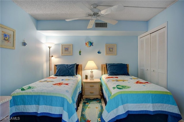 bedroom featuring ceiling fan, a closet, and a textured ceiling