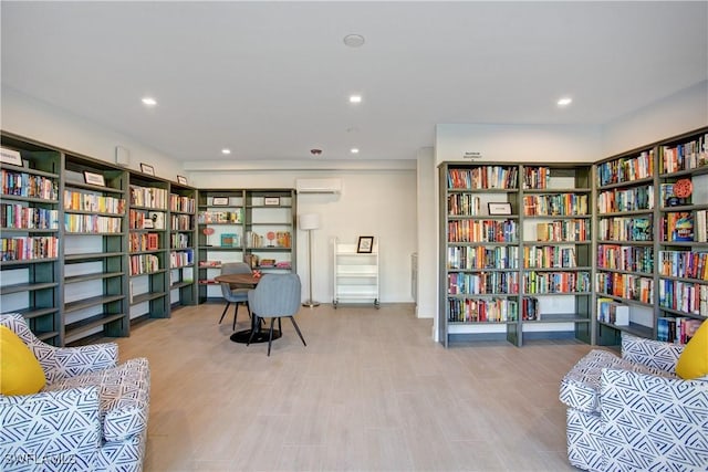 living area with a wall mounted air conditioner