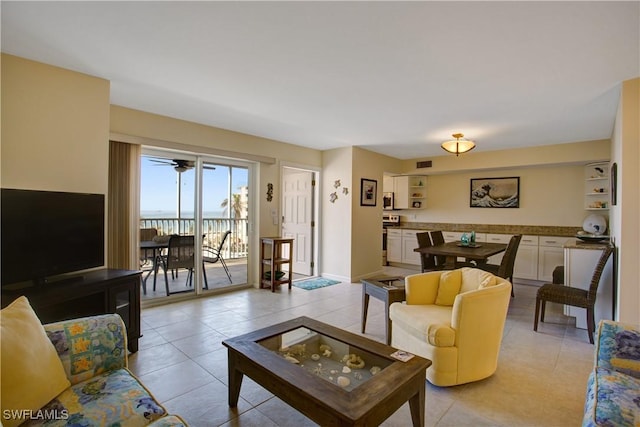 tiled living room featuring a water view