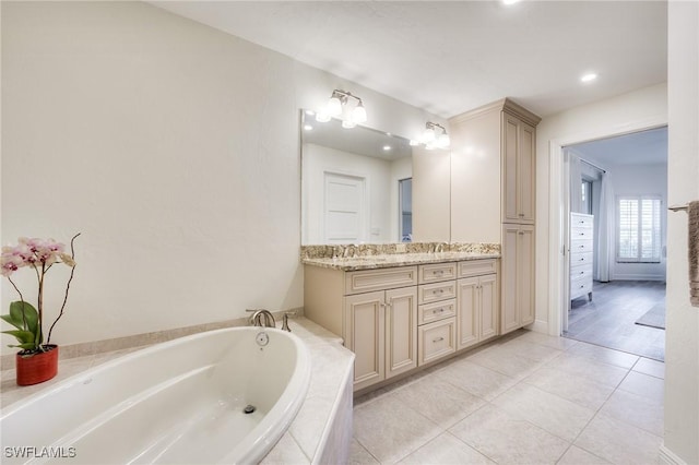 bathroom with vanity, tile patterned floors, and tiled bath