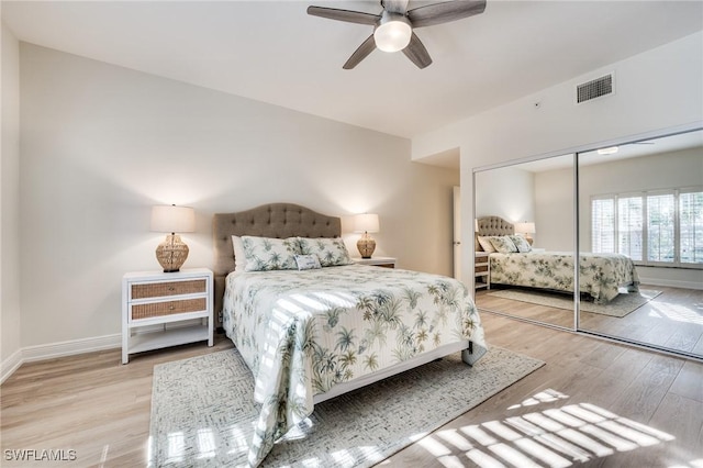 bedroom featuring ceiling fan, a closet, and light hardwood / wood-style flooring