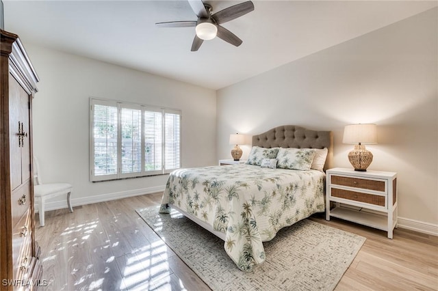 bedroom with ceiling fan and light hardwood / wood-style floors