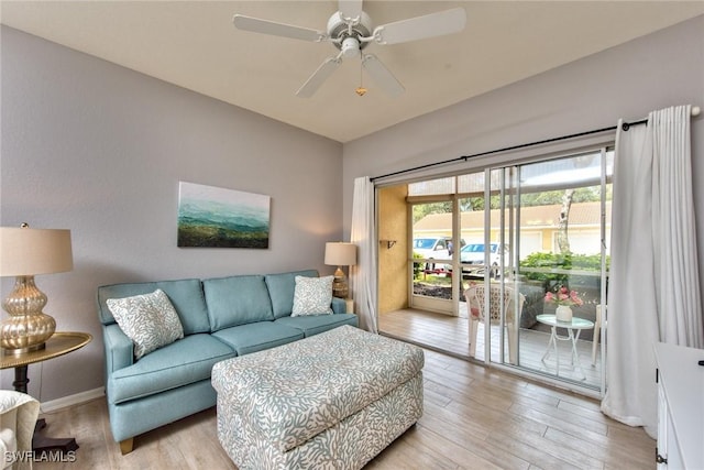 living room featuring ceiling fan and light hardwood / wood-style flooring