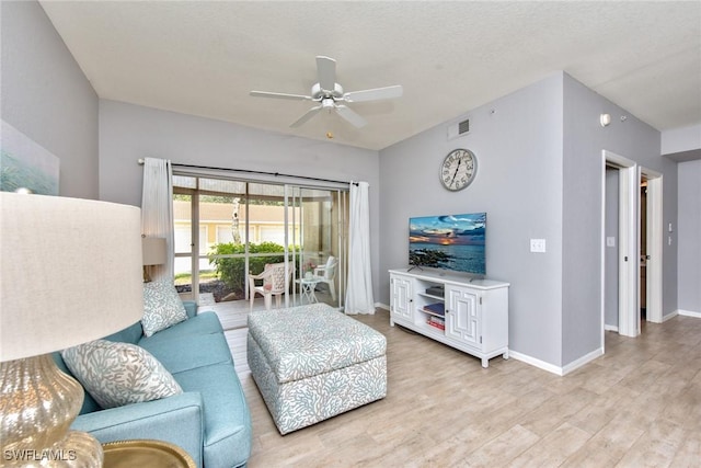 living room featuring ceiling fan and light wood-type flooring