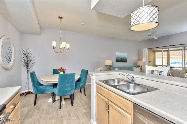 kitchen with pendant lighting, sink, light hardwood / wood-style floors, light brown cabinetry, and stainless steel dishwasher