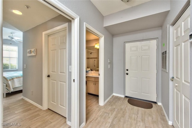 entryway with ceiling fan and light hardwood / wood-style flooring