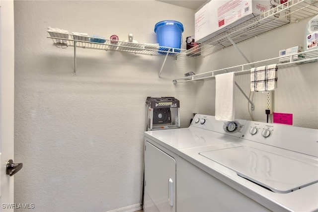 washroom with washer and dryer