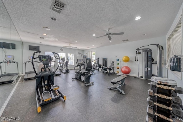 workout area featuring ceiling fan and a textured ceiling