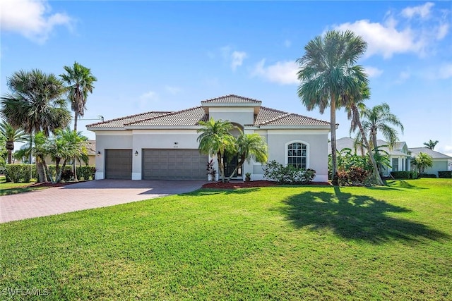 mediterranean / spanish-style house with a garage and a front yard