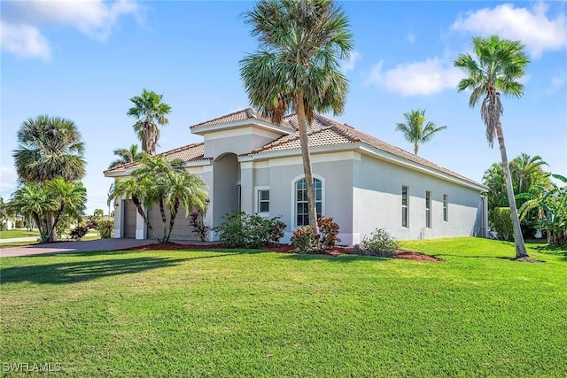 view of side of property featuring a garage and a lawn