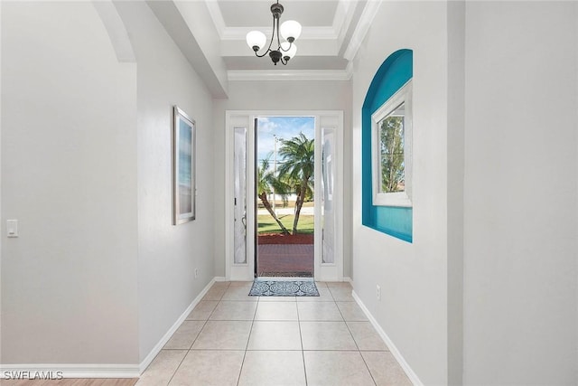 doorway with ornamental molding, a chandelier, and light tile patterned floors