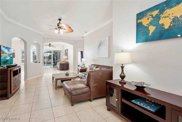 living room featuring ornamental molding, light tile patterned flooring, and ceiling fan