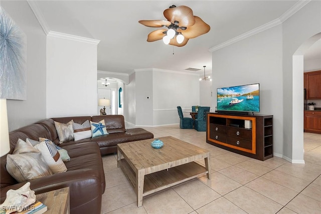 tiled living room with crown molding and ceiling fan with notable chandelier