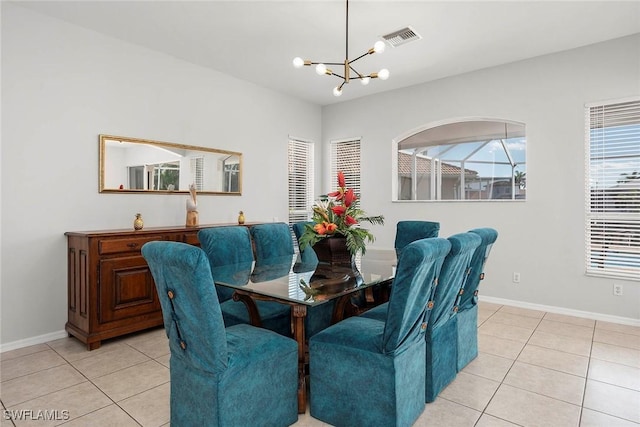 dining space with light tile patterned flooring and a chandelier