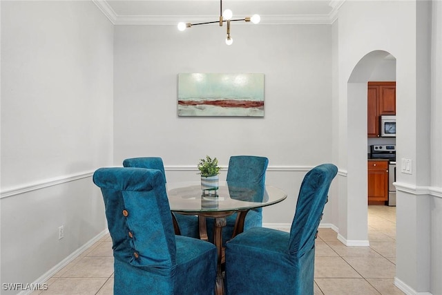 tiled dining space featuring crown molding and a chandelier