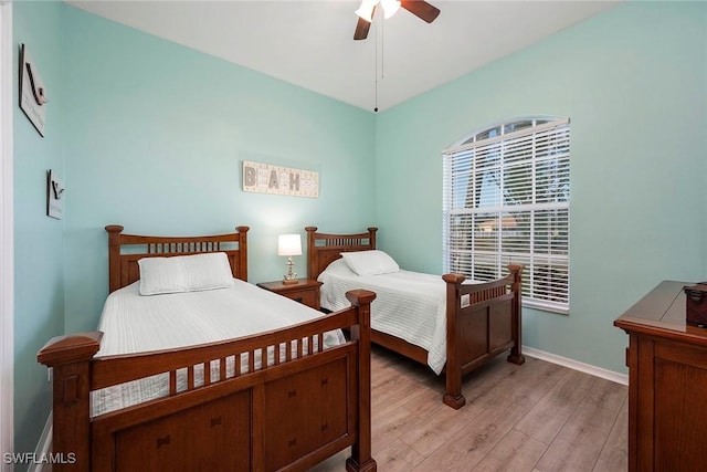 bedroom with light hardwood / wood-style floors and ceiling fan