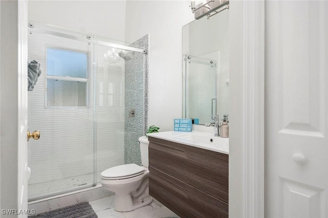 bathroom with a shower with door, vanity, and toilet