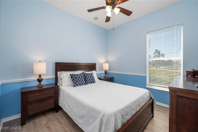 bedroom featuring light wood-type flooring and ceiling fan