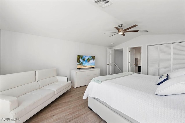 bedroom featuring vaulted ceiling, light hardwood / wood-style floors, a closet, and ceiling fan