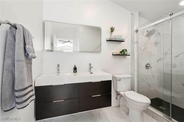 bathroom with vanity, ceiling fan, a shower with shower door, and toilet