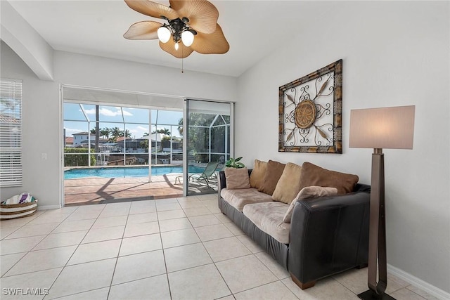 tiled living room with plenty of natural light and ceiling fan