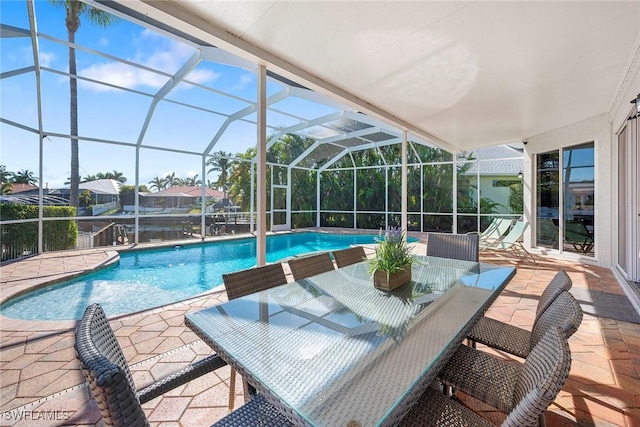 view of swimming pool with a patio and glass enclosure