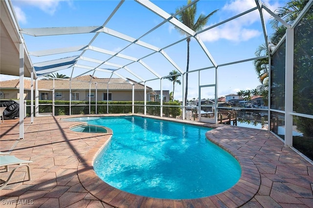 view of swimming pool with a water view, a lanai, and a patio